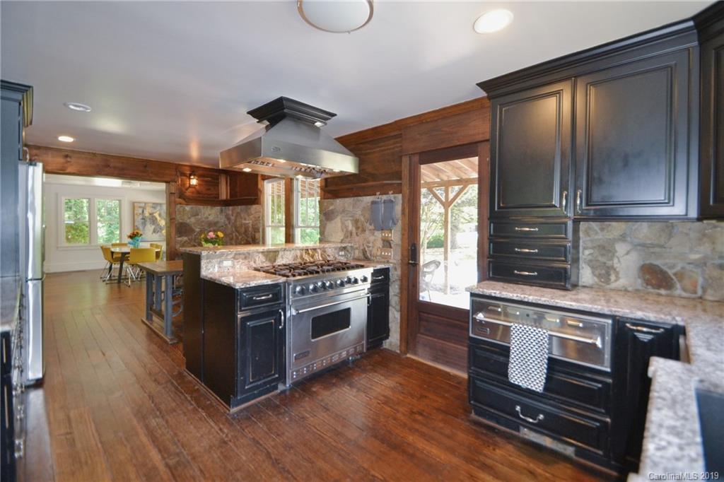 3431 Lee Moore Road Maiden, NC 28650 - Photo 11 of 44 a kitchen with stainless steel appliances granite countertop a stove and a wooden floors