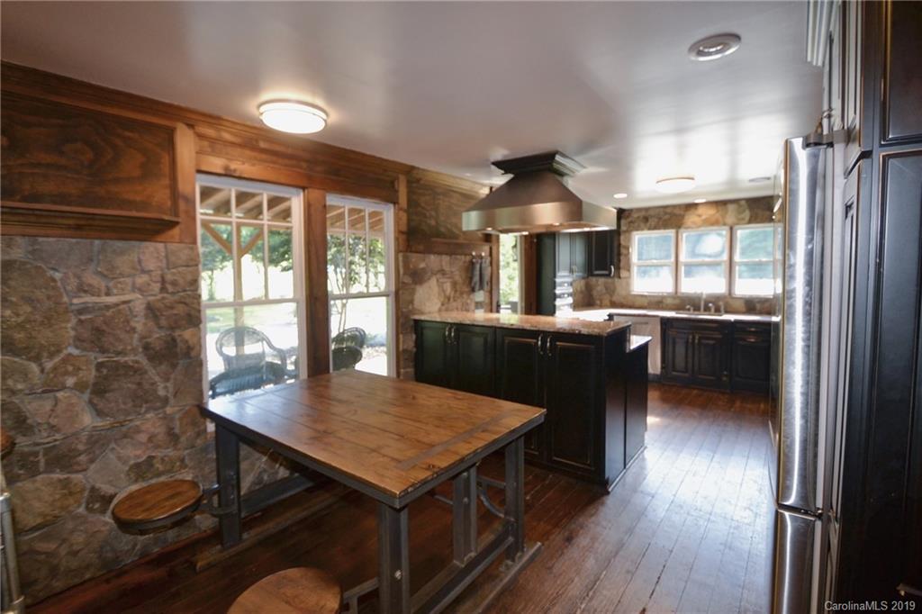 3431 Lee Moore Road Maiden, NC 28650 - Photo 13 of 44 a kitchen with a table chairs and wooden floor