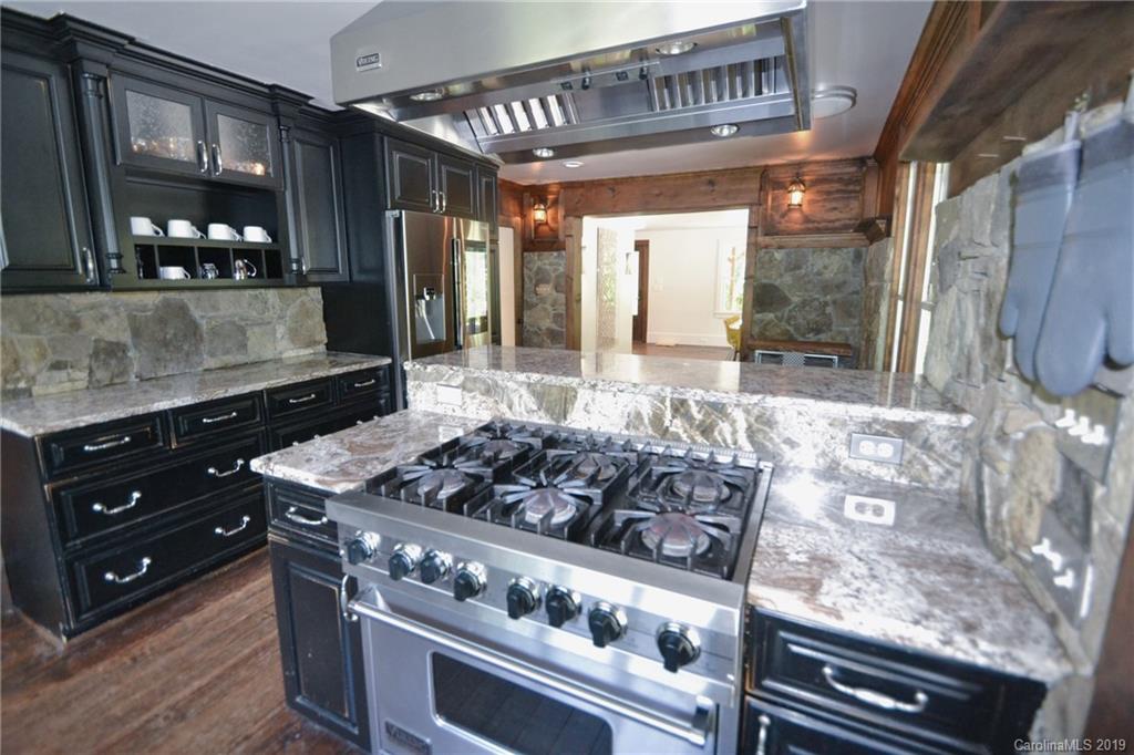 3431 Lee Moore Road Maiden, NC 28650 - Photo 14 of 44 a kitchen with stainless steel appliances granite countertop a stove and a wooden cabinets