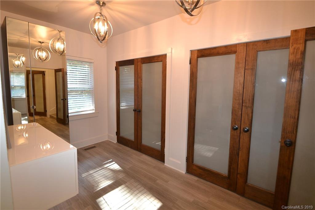 3431 Lee Moore Road Maiden, NC 28650 - Photo 19 of 44 a view of a hallway with wooden floor and a bathroom