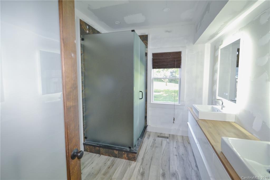 3431 Lee Moore Road Maiden, NC 28650 - Photo 22 of 44 a bathroom with a tub shower and sink