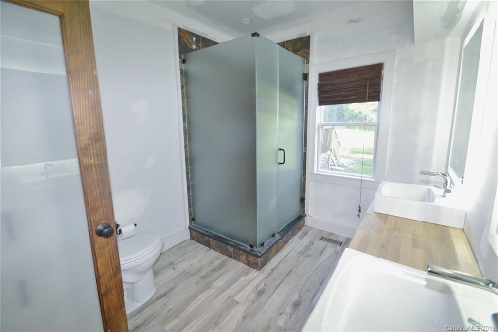 3431 Lee Moore Road Maiden, NC 28650 - Photo 23 of 44 a view of a hallway with wooden floor and a livingroom