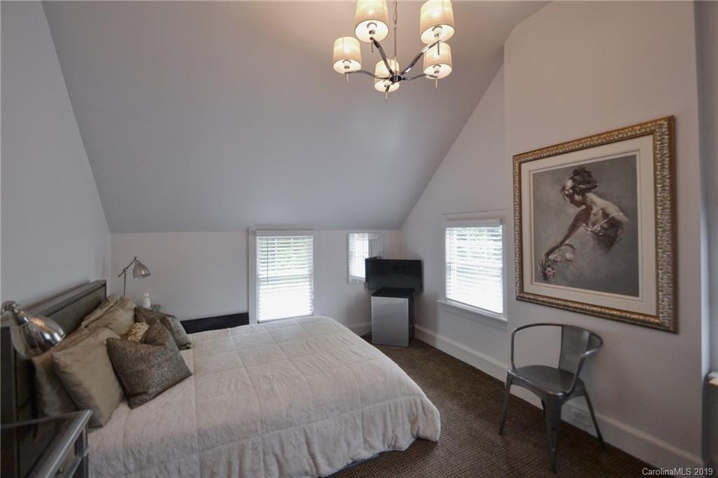 3431 Lee Moore Road Maiden, NC 28650 - Photo 25 of 44 a bedroom with a bed and a chandelier
