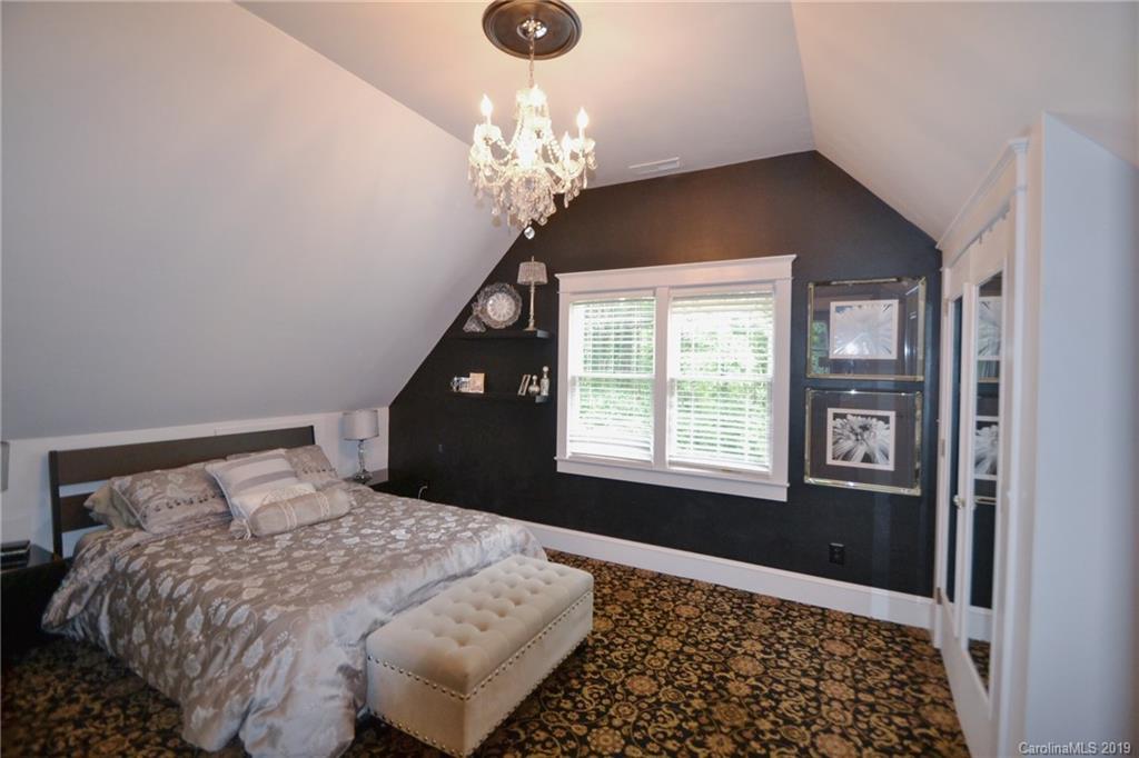 3431 Lee Moore Road Maiden, NC 28650 - Photo 31 of 44 a bedroom with a large bed and a chandelier
