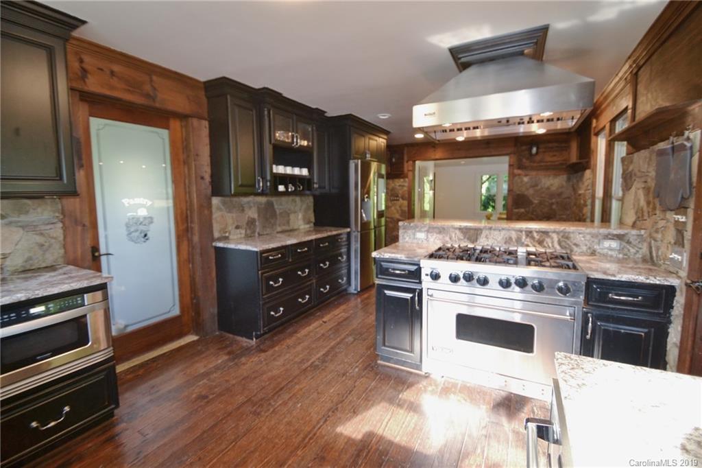 3431 Lee Moore Road Maiden, NC 28650 - Photo 10 of 44 a kitchen with stainless steel appliances kitchen island granite countertop a stove and a sink