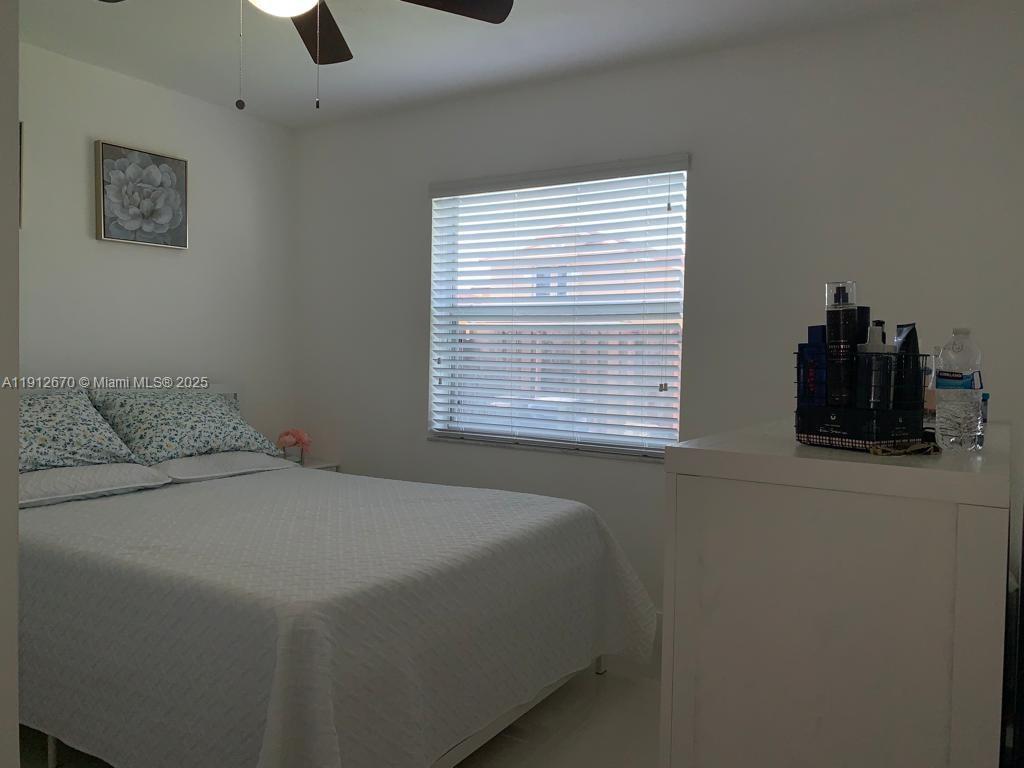 14804 Southwest 155th Place Miami, FL 33196 - Photo 12 of 35 a bedroom with a bed and a window