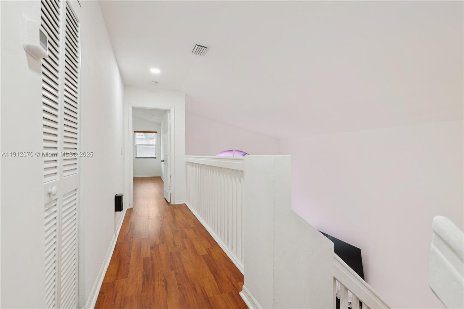 14804 Southwest 155th Place Miami, FL 33196 - Photo 13 of 35 a view of a hallway with wooden floor and staircase