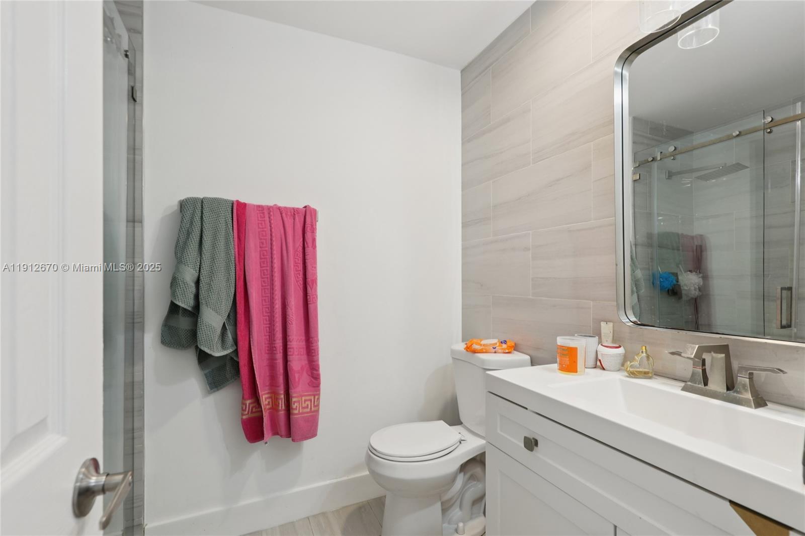 14804 Southwest 155th Place Miami, FL 33196 - Photo 14 of 35 a bathroom with a sink toilet and shower