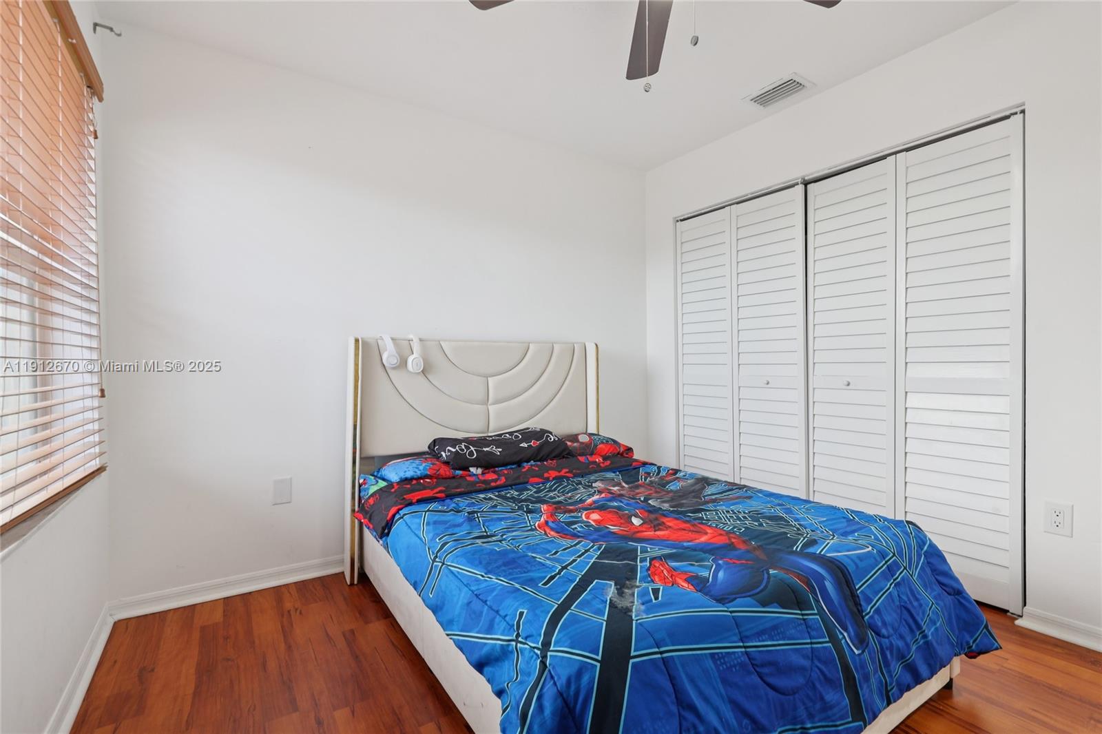 14804 Southwest 155th Place Miami, FL 33196 - Photo 17 of 35 a bedroom with a bed and a window