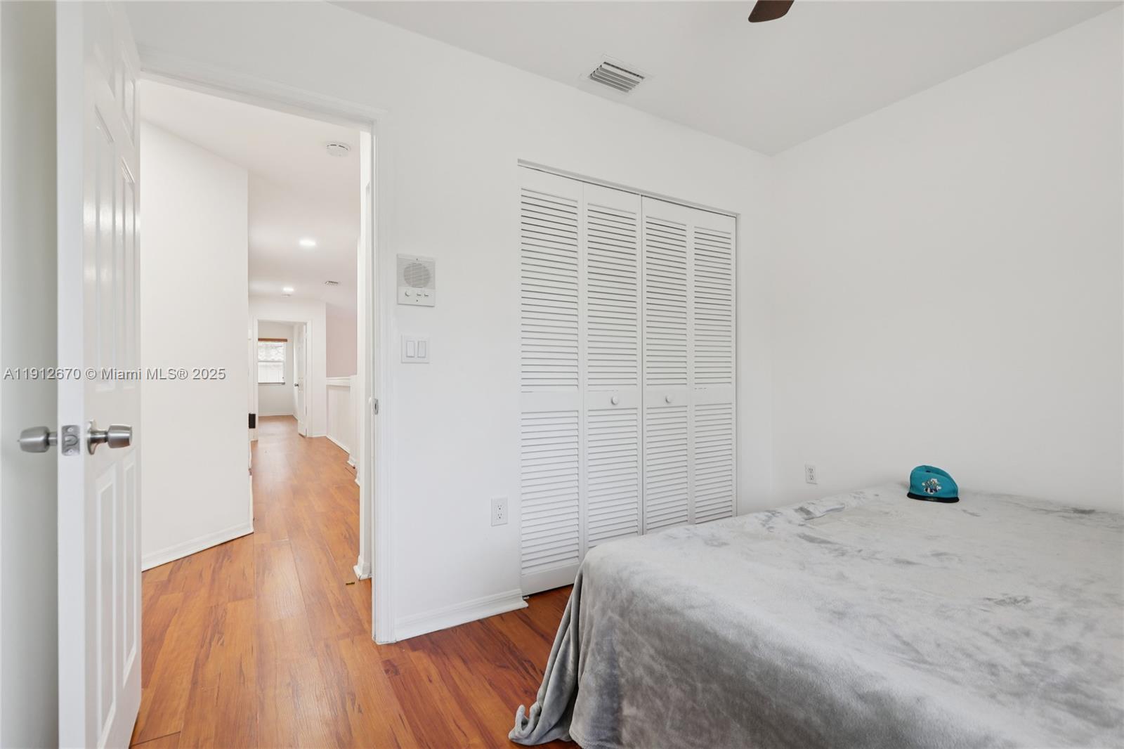 14804 Southwest 155th Place Miami, FL 33196 - Photo 21 of 35 a bedroom with a bed and wooden floor