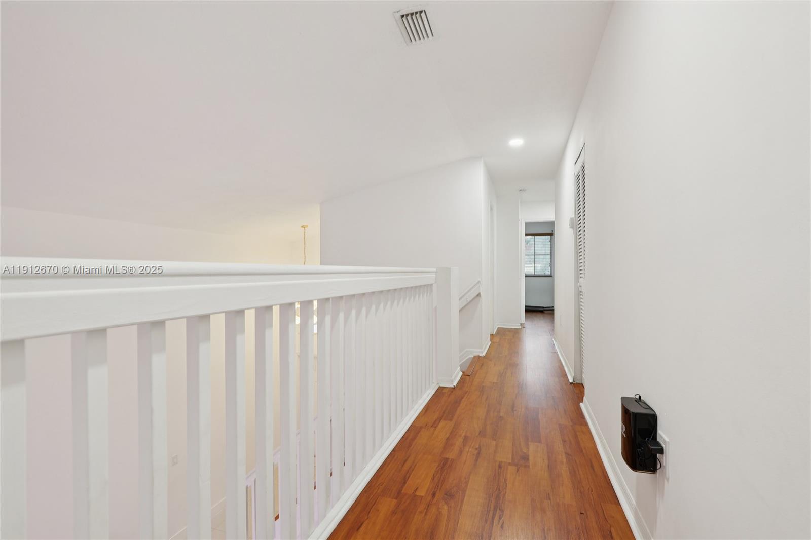 14804 Southwest 155th Place Miami, FL 33196 - Photo 22 of 35 a view of a hallway with wooden floor