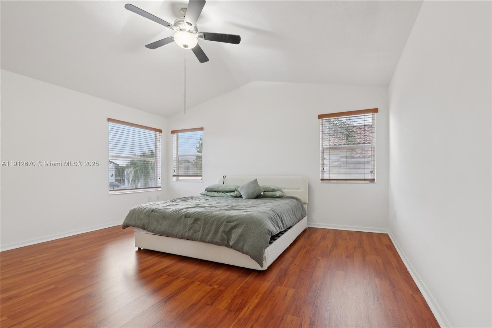 14804 Southwest 155th Place Miami, FL 33196 - Photo 23 of 35 a spacious bedroom with a bed and a window