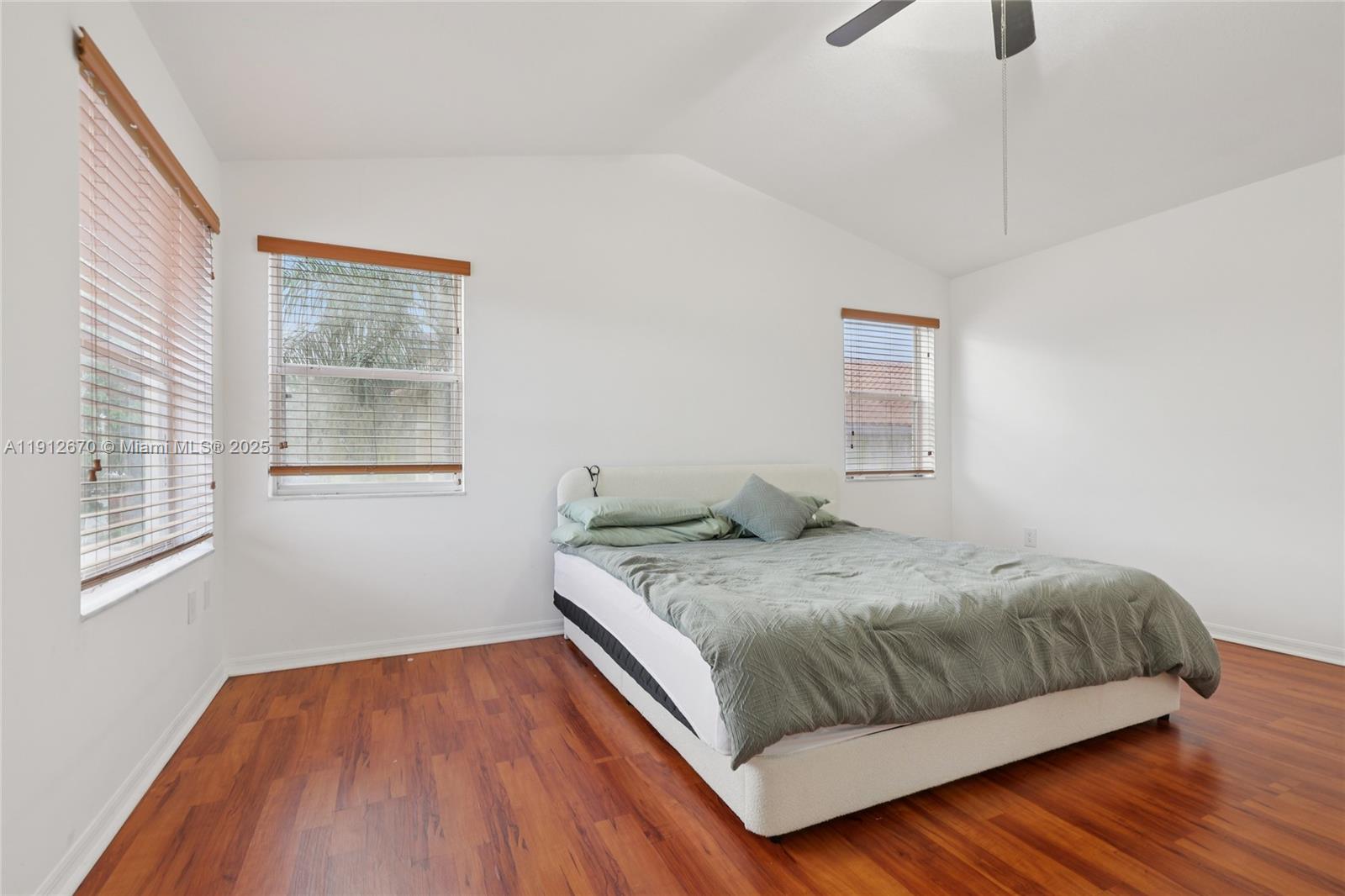 14804 Southwest 155th Place Miami, FL 33196 - Photo 24 of 35 a bedroom with a bed and wooden floor