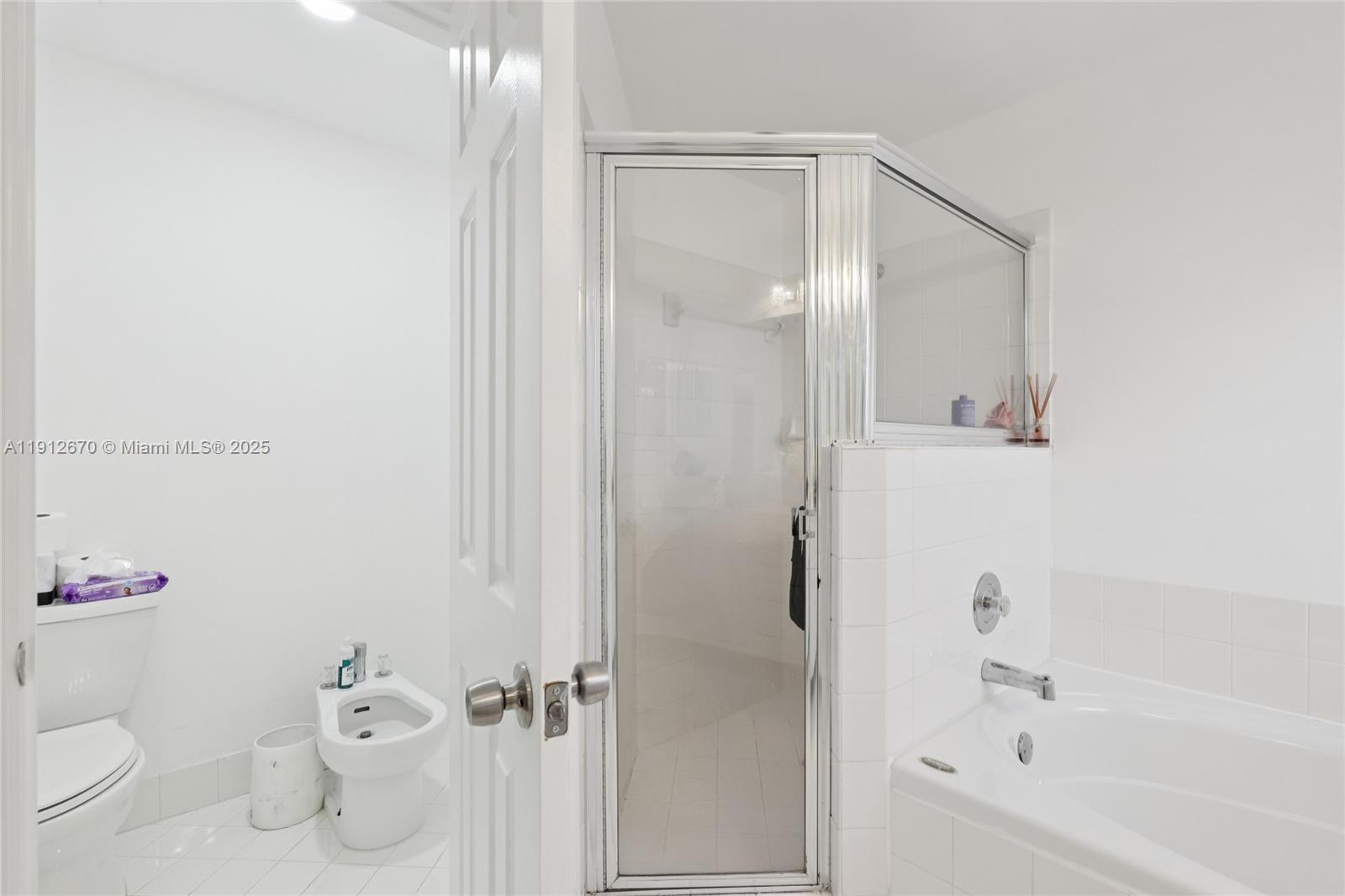 14804 Southwest 155th Place Miami, FL 33196 - Photo 29 of 35 a bathroom with a bathtub and a shower