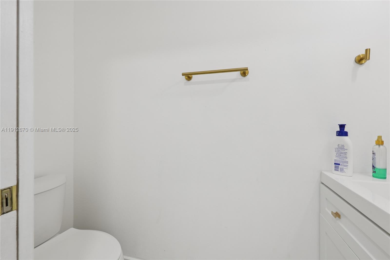 14804 Southwest 155th Place Miami, FL 33196 - Photo 30 of 35 a bathroom with a toilet sink and vanity