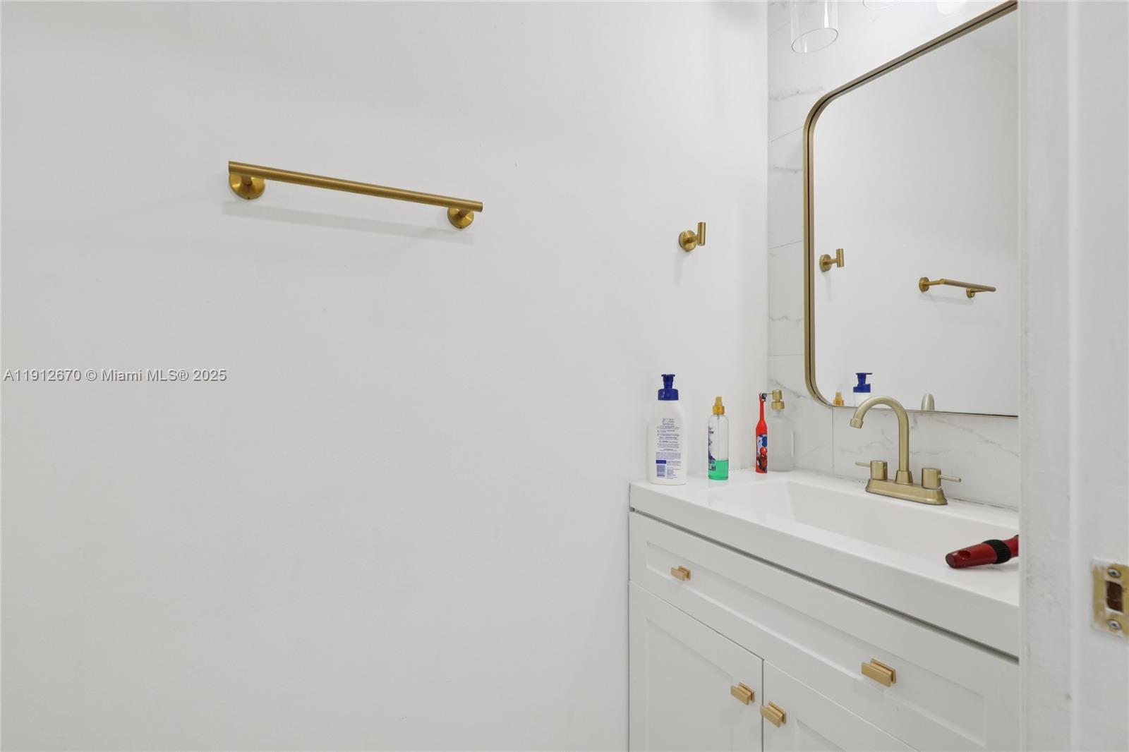 14804 Southwest 155th Place Miami, FL 33196 - Photo 31 of 35 a bathroom with a sink and a mirror