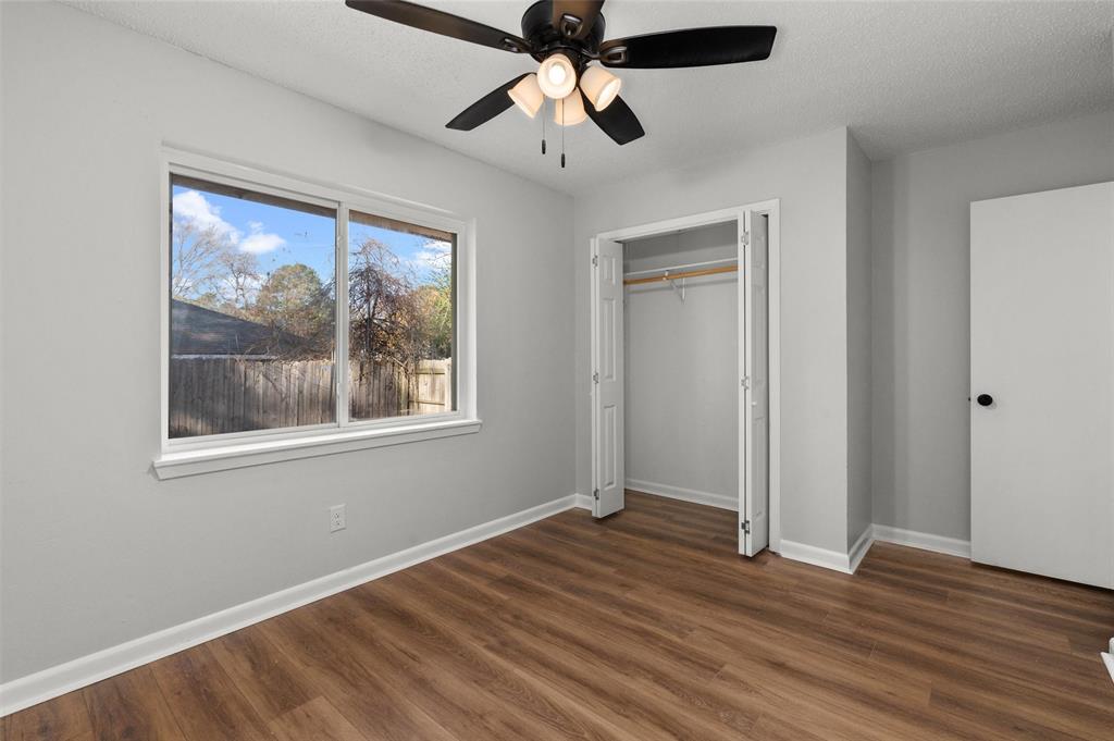 809 Princesa Drive Haughton, LA 71037 - Photo 13 of 17 a view of empty room with wooden floor and fan