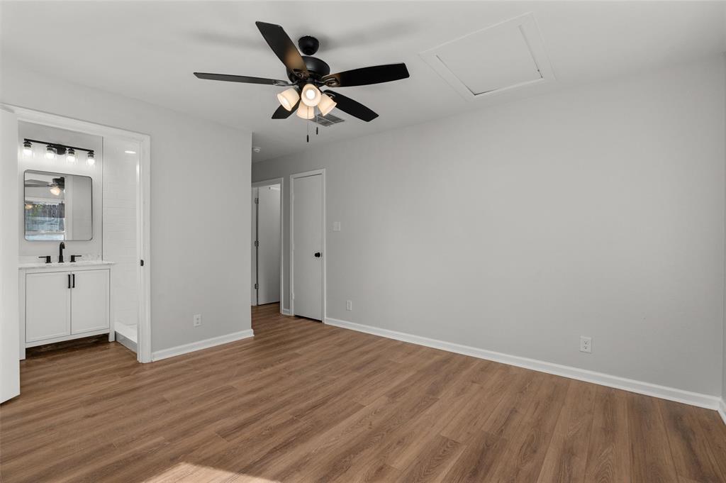 809 Princesa Drive Haughton, LA 71037 - Photo 10 of 17 an empty room with wooden floor chandelier fan and windows