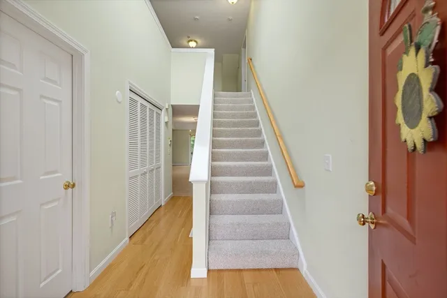 a view of staircase with white walls and railing