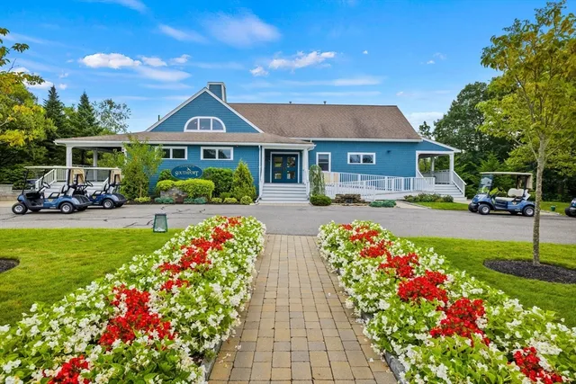 a front view of house with yard and outdoor seating