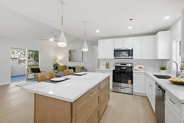 a kitchen with a sink a stove and cabinets