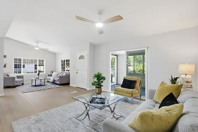 a living room with furniture and a potted plant