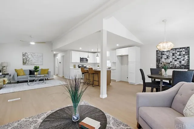 a living room with furniture a chandelier and a table