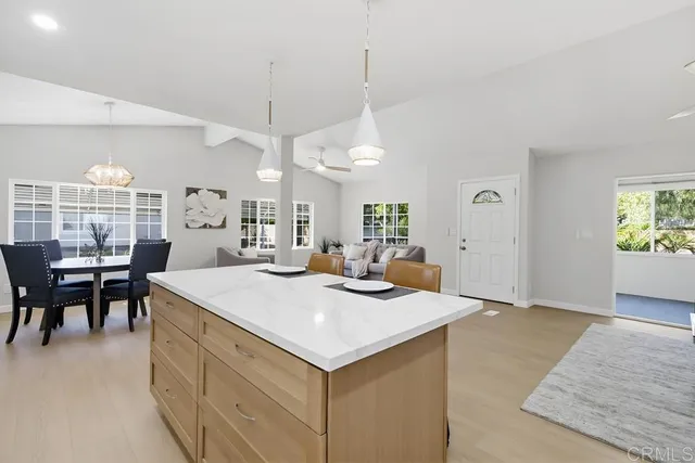 a view of kitchen island a sink and living room