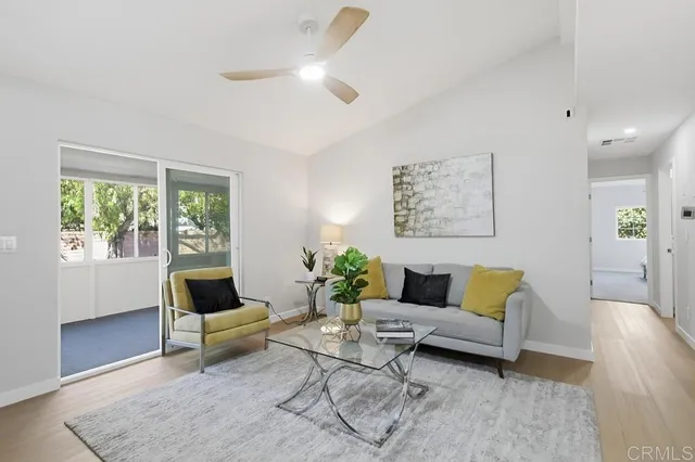 a living room with furniture and a potted plant