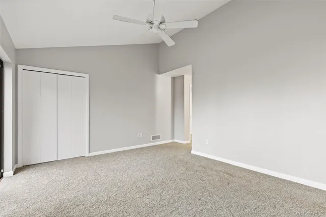 an empty room with a ceiling fan