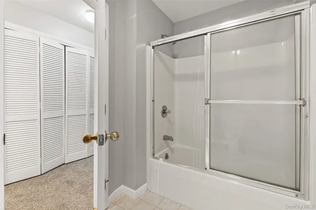 a bathroom with a shower and a bath tub