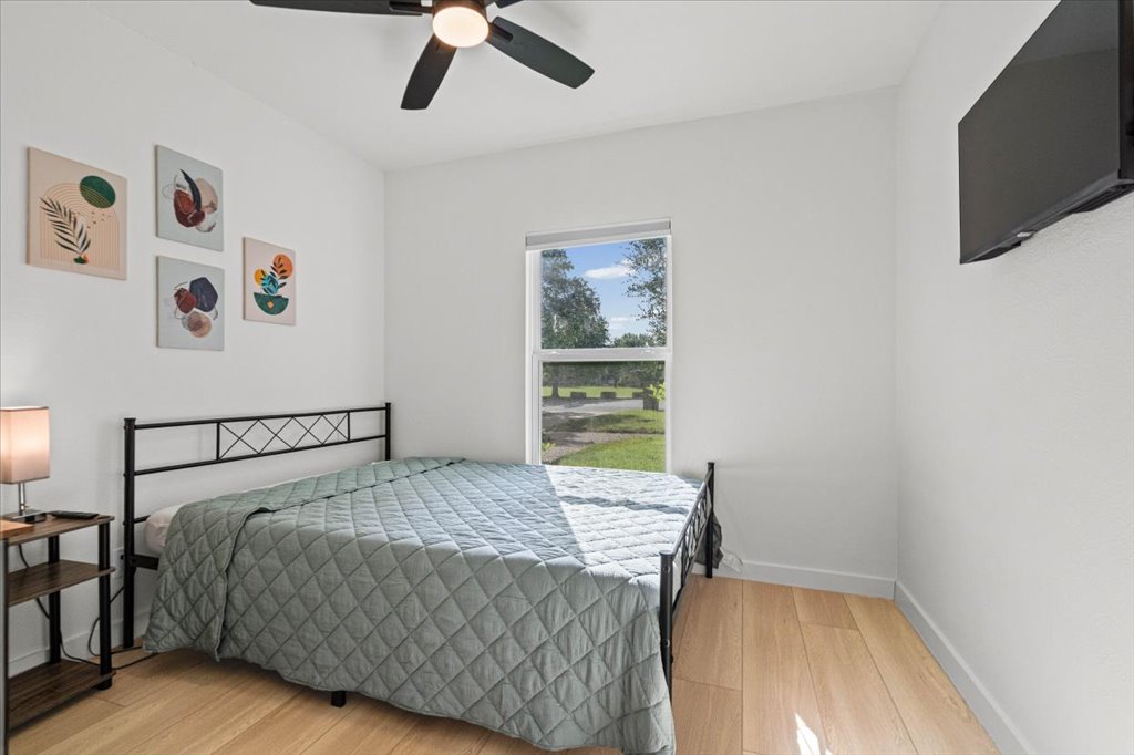 1406 North Georgetown Street Round Rock, TX 78664 - Photo 6 of 34 A quiet retreat, this bedroom offers light wood floors and a sun-filled window.