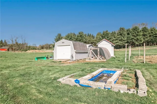 a view of a backyard with a garden and entertaining space