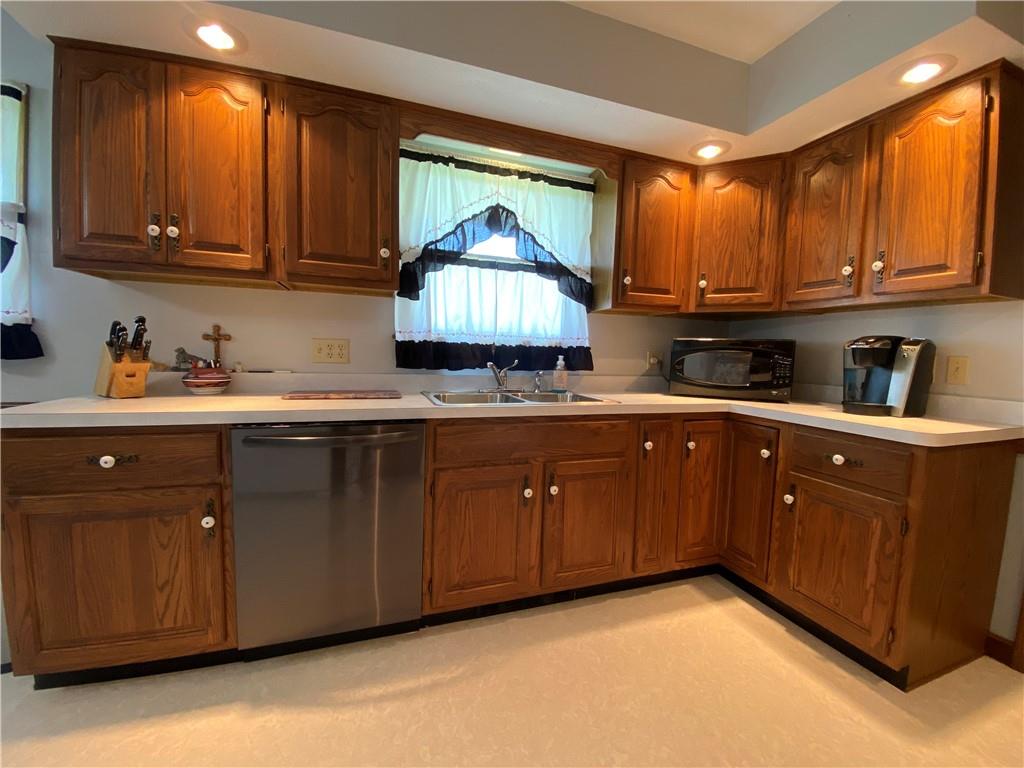 240 Hamburg Road Greenville, PA 16125 - Photo 26 of 46 a kitchen with a sink a cabinets and wooden cabinets