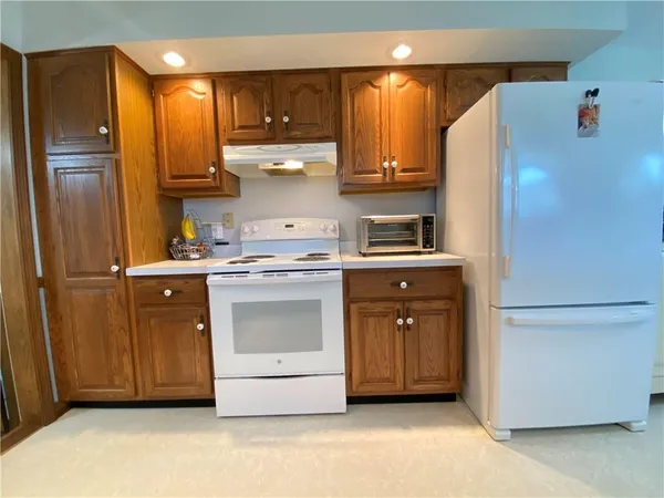 a kitchen with stainless steel appliances a stove a refrigerator and cabinets