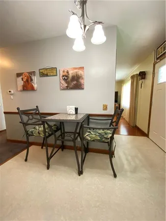 a dining room with furniture and a chandelier