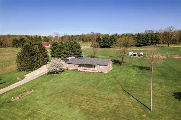 a backyard of a house with table and chairs
