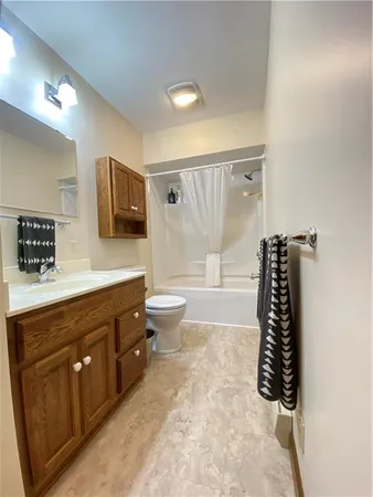 a bathroom with a double vanity sink a large mirror and shower