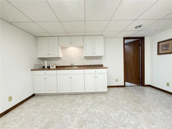 a kitchen with granite countertop white cabinets and stainless steel appliances