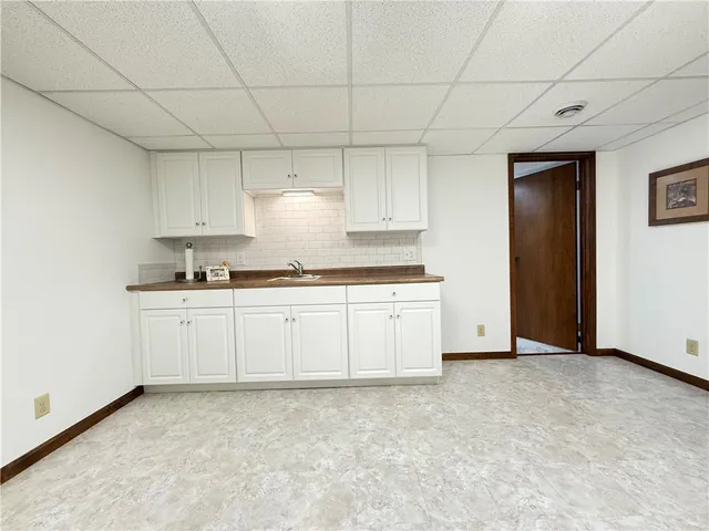 a kitchen with granite countertop white cabinets and stainless steel appliances