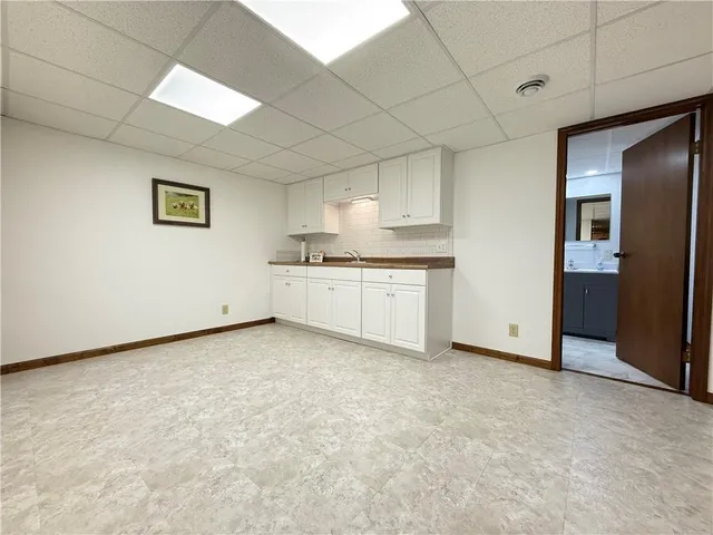 a view of a kitchen with white cabinets