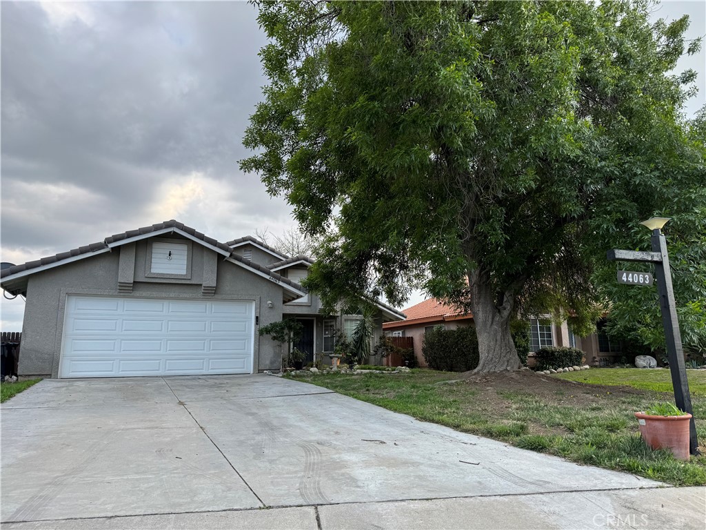 44063 Lately Circle Hemet, CA 92544 - Photo 5 of 75 a front view of a house with a yard and garage