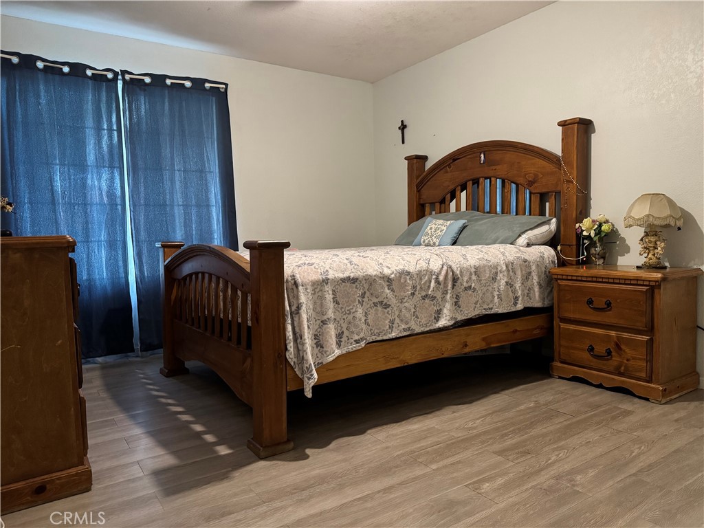 44063 Lately Circle Hemet, CA 92544 - Photo 53 of 75 a bedroom with a bed and wooden floor
