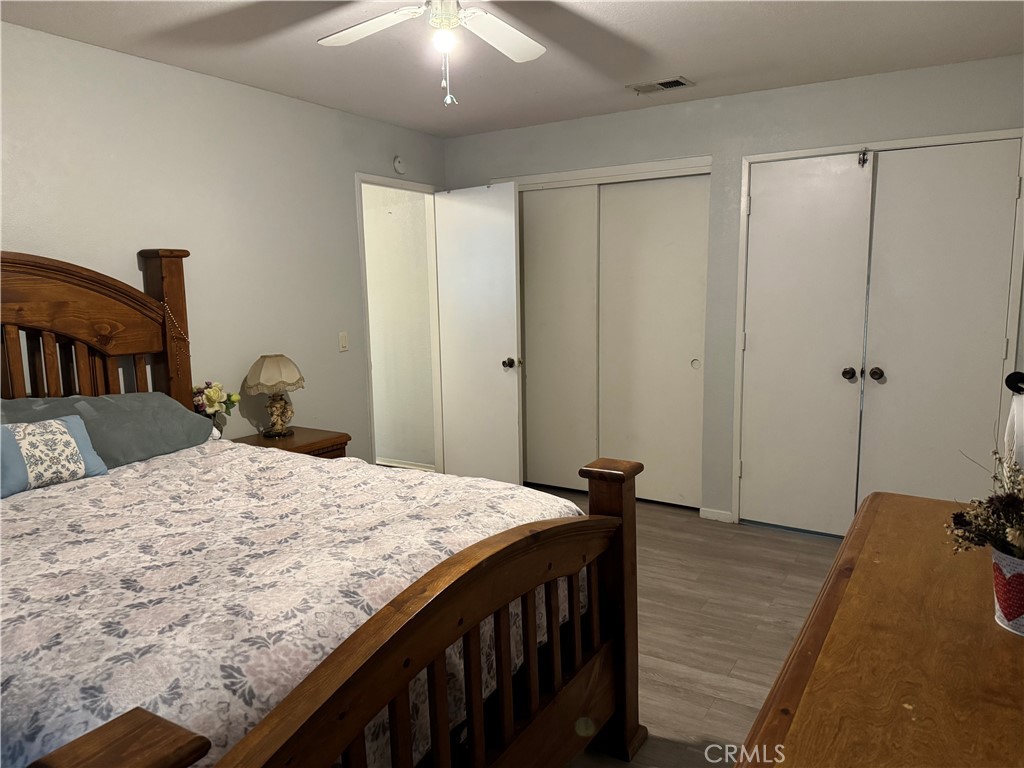 44063 Lately Circle Hemet, CA 92544 - Photo 55 of 75 a bedroom with a bed and wooden floor