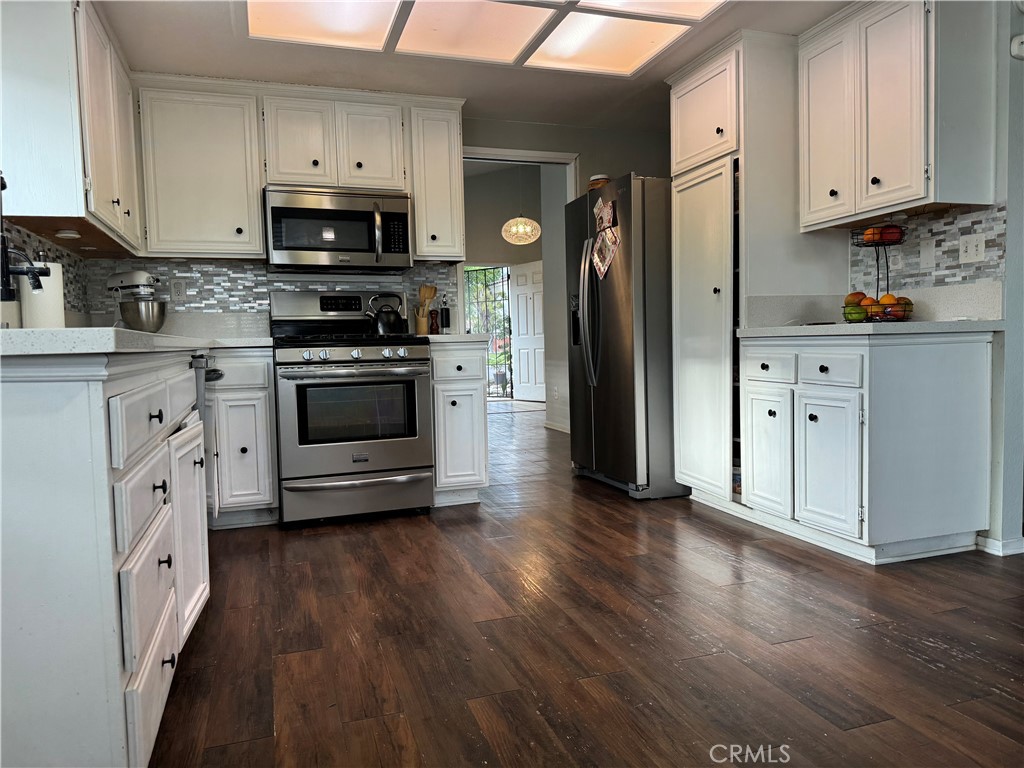 44063 Lately Circle Hemet, CA 92544 - Photo 6 of 75 a kitchen with stainless steel appliances a sink cabinets and wooden floor