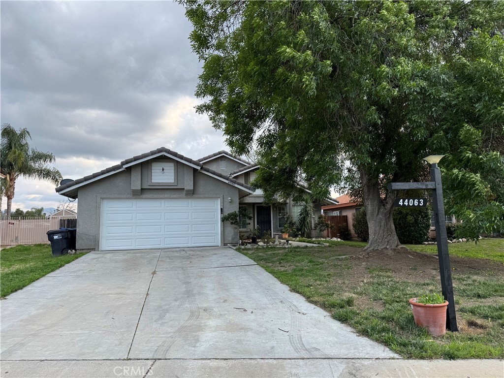 44063 Lately Circle Hemet, CA 92544 - Photo 75 of 75 a front view of a house with a yard and garage