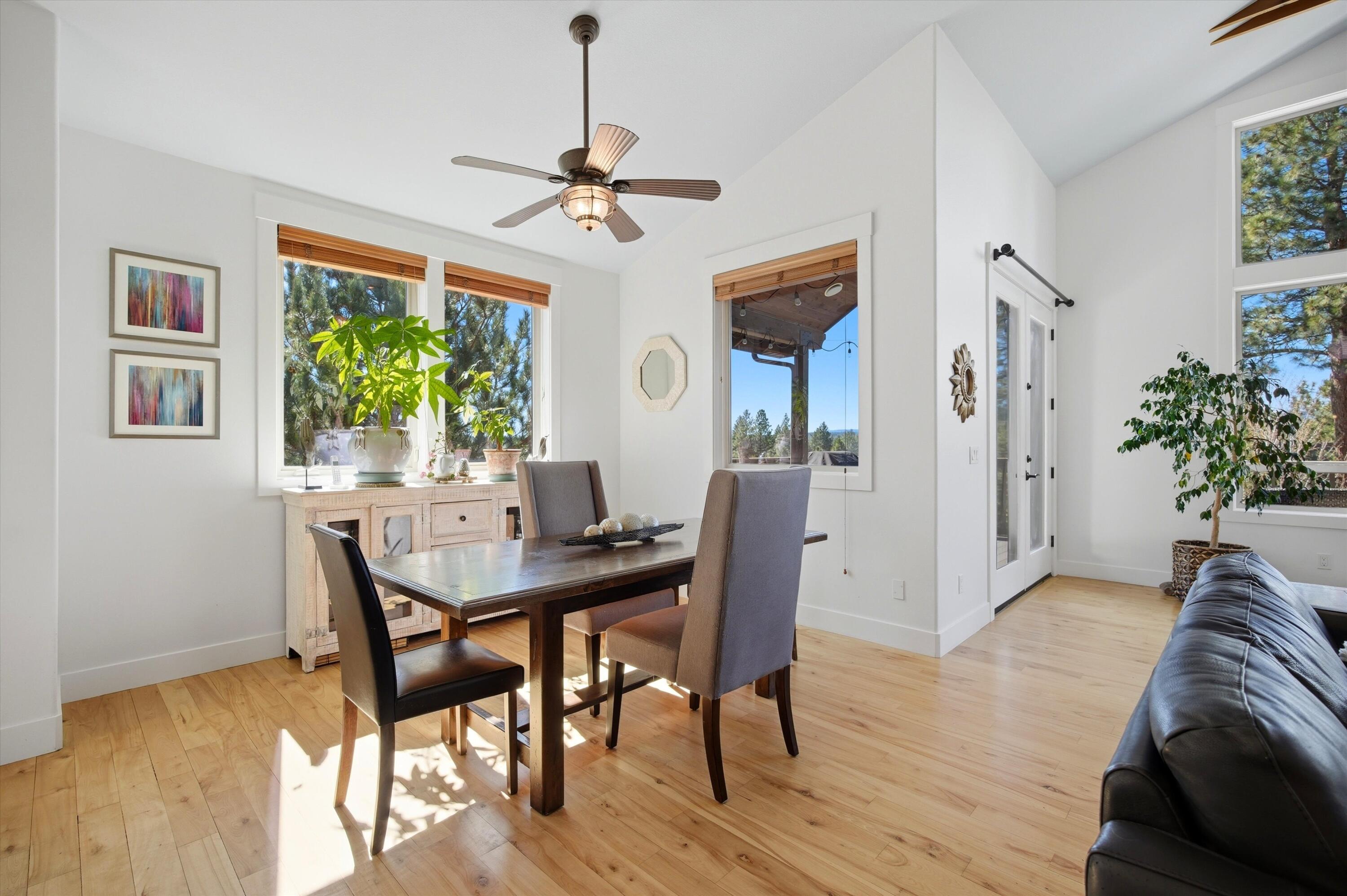 15 Southwest Quail Butte Place Bend, OR 97703 - Photo 22 of 55 a view of a dining room with furniture window and wooden floor