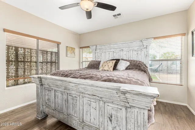 a bedroom with a large bed and a large window