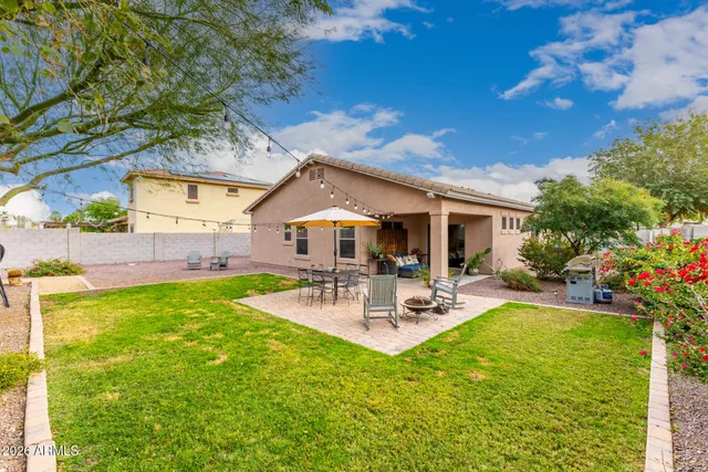 a view of a backyard with sitting area