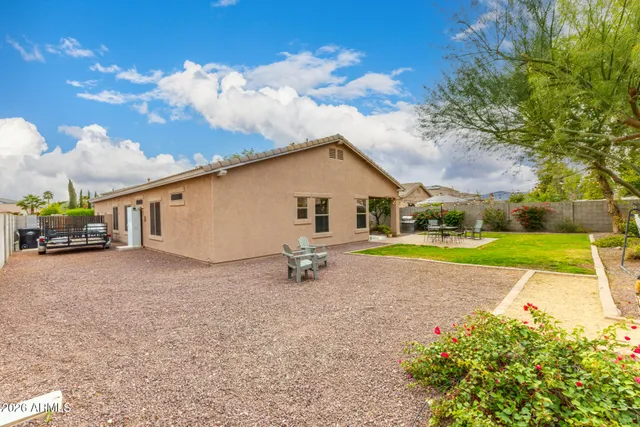 a view of a patio with couches table and chairs and potted plants